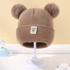 Bonnet bébé tricoté chaud avec pompon