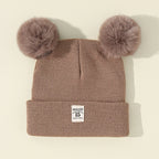 Bonnet bébé tricoté chaud avec pompon