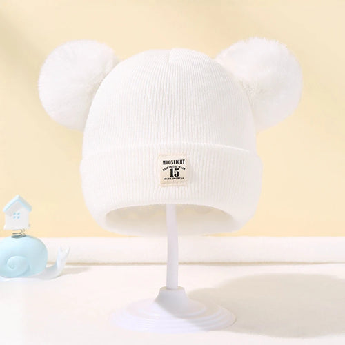 Bonnet bébé tricoté chaud avec pompon